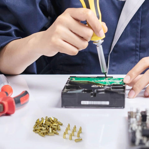Technician assembling a PC with M3 Brass Hex Standoff Spacers Set For PC Build And Motherboard 50 Pieces With Male To Female Threads 9mm And 4mm Lengths