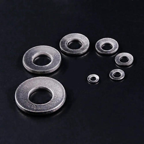 Assorted 304 stainless steel Belleville spring washers in M3 to M12 sizes on black background