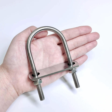 Set of 8 M8 U Bolts in 304 Stainless Steel With Nuts Washers and Bolt Plate 50mm Wide by 100mm Long Corrosion Resistant Mounting Hardware for Pipe Bar and Tube displayed on a hand