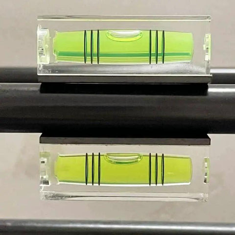 Magnetic Square Bubble Level Set Of 5 Pieces With 29mm 40mm And 52mm Levels For Quick Layouts And Precise Measurements In Carpentry And DIY Projects Strong Magnets Lightweight Aluminum Build Makes It Easy To Hang And Use All Day showing a close-up of a 29mm level on metal surface.