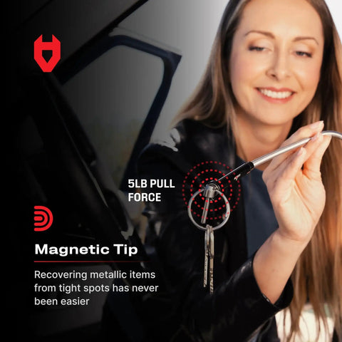 Woman using a flexible magnetic claw pickup tool with a bright LED light to retrieve keys from a tight spot, 5lb pull strength.