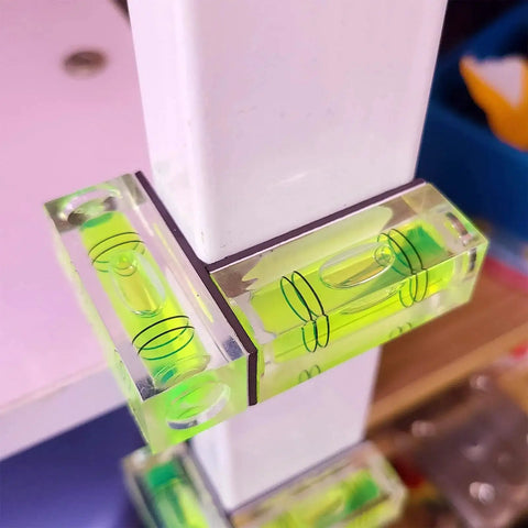 Magnetic Mini Bubble Level Tool Pack, Pocket Size, Ultra Precise 3Line Grid in use on white furniture for horizontal alignment