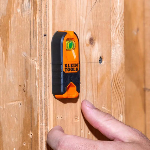 Compact Magnetic Stud Finder And Level With Bubble Vial for wood detection, installed on wooden surface.