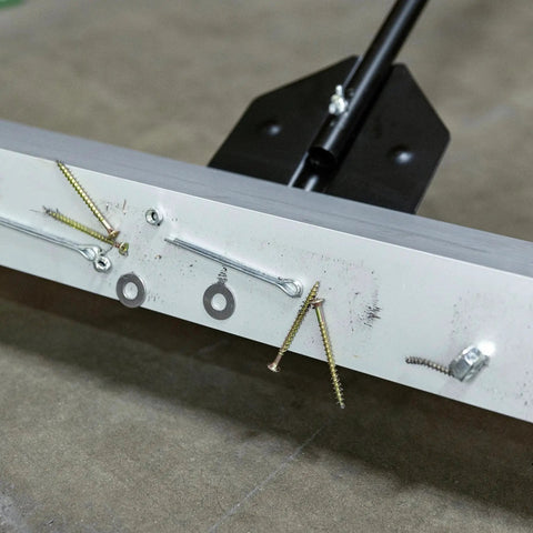 Close-up of 24 Inch Rolling Magnetic Floor Sweeper With 50 Pound Capacity And Adjustable Handle, picking up screws and nails.