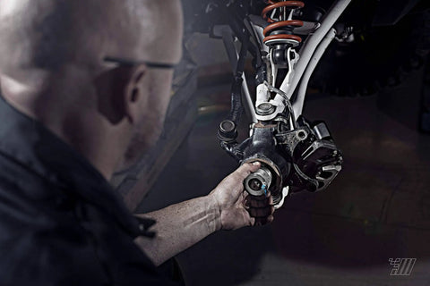 Mechanic installing 44mm Wheel Bearing Greaser For Polaris RZR 900 1000 And Pro XP Jansen Motorsports Wheel Bearing Grease Packer
