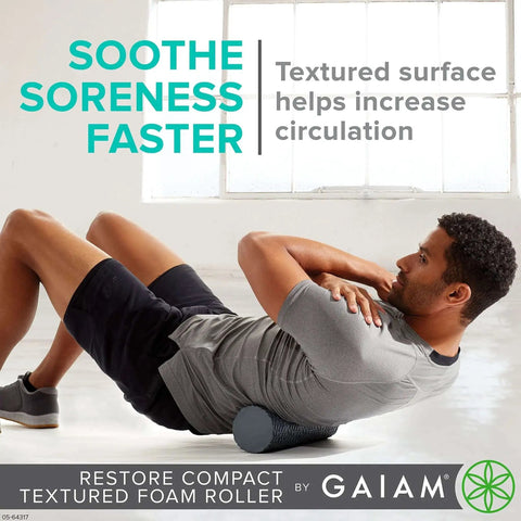 Man using Compact Textured Foam Roller for Muscle Recovery and Massage, 12 inch length, 4 inch diameter, in a gym setting