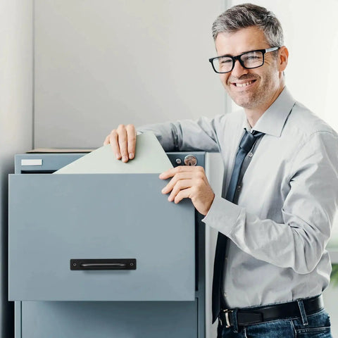 Office worker using a filing cabinet with a 12 Pack Black Barn Door Handles 5.8 Inch Aluminum Alloy Cabinet Pulls With 24 Screws Durable Sliding Door Handles for Cabinets Wardrobe Closet Shed Garage Cupboard and Drawer Doors installed.