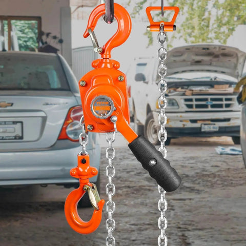 Manual Lever Chain Hoist 1/2 Ton 1100 Lbs Capacity 5 Ft in garage with open car trunks, showcasing orange G80 chain and 360° hook