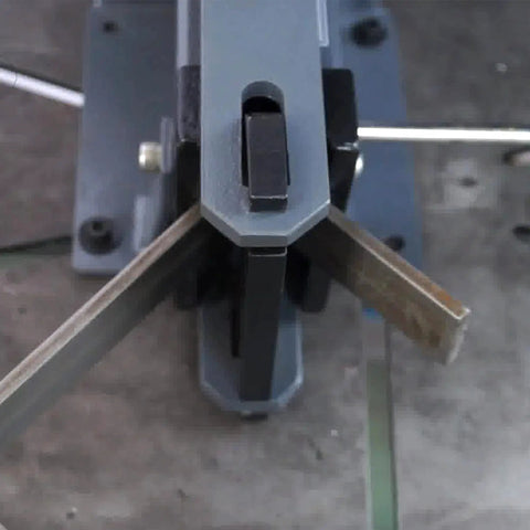 Top view of a manual steel bending brake in use, showing 90-degree bend on steel with bench top mount. Manual Steel Bending Brake With Four Inch Capacity And 2.5 Ton Press Bench Top Mounted 90 Degree Bender For Three Sixteenth Inch Steel And Three Eighth Inch Aluminum.
