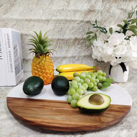 Large Marble And Acacia Wood Lazy Susan Turntable Rotating Serving Tray with assorted fruits and flowers on a dining table.