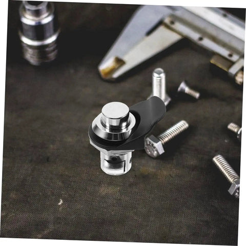Close-up of chrome push-button latch with black mounting arm for cabinets or boats.