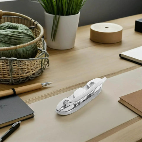 Folding stainless steel boat cleat, 4.5-inch, chrome finish, displayed on a wooden desk.