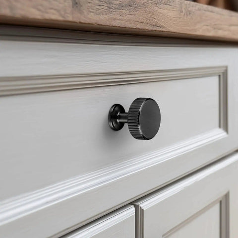 Close-up of matte black knob from 20-Pack Matte Black Cabinet Knobs For Kitchen Cabinets And Drawers, solid zinc alloy with brushed finish.