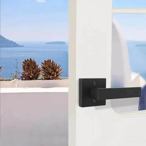 Matte Black Square Dummy Door Lever on white door with sea view, part of 4 Pack For French Doors And Closet Hardware Non Turning Exposed Screws