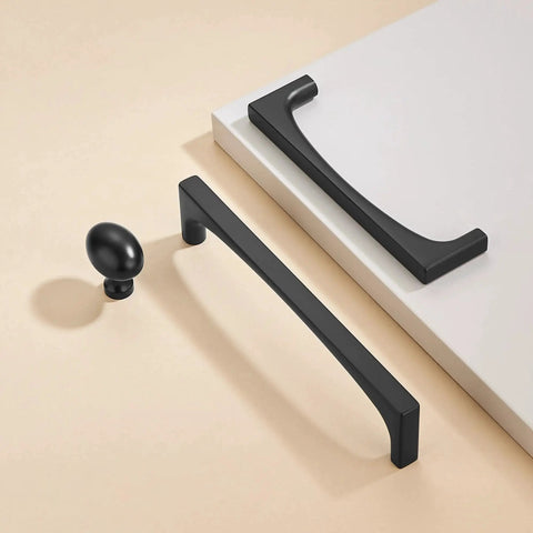 10 Pack Matte Black Oval Cabinet Knobs Single Hole Cabinet Pulls showcased with dresser unit, made of solid zinc alloy for modern home use.