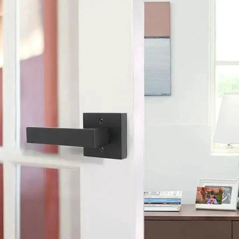 Matte Black Square Dummy Door Levers 4 Pack For French Doors And Closet Hardware installed on a white interior door.