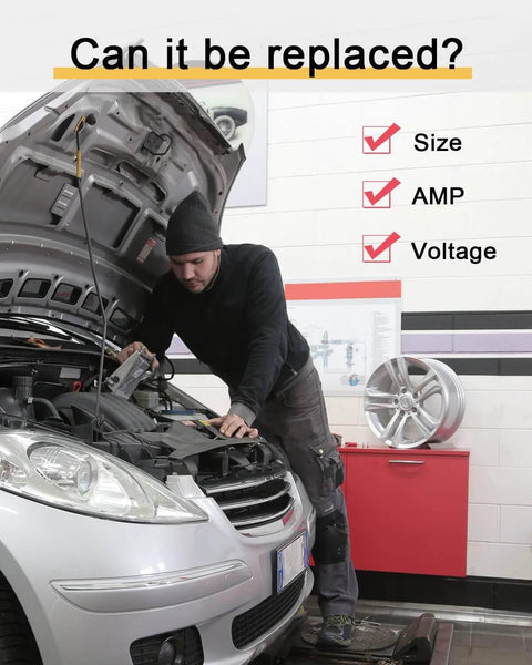 Mechanic working under the hood of a car in a garage with checklist for size, AMP, voltage; tire and tools in background.