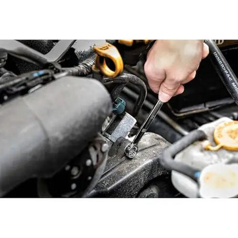 Using Durable 247-Piece Mechanic Tool Set With One Quarter, Three Eighths, And One Half Inch Drives on car engine, polished chrome finish