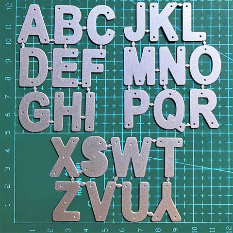 26 Capital Alphabet Dies Set For Metal Cutting, Card Making, Scrapbooking And DIY Embossing Projects on a green cutting mat