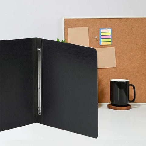 Open black folder with Premium 3 Inch Capacity Metal Prong Paper Fasteners Pack Of 50 With 8.5 Inch Base on a desk near a corkboard.