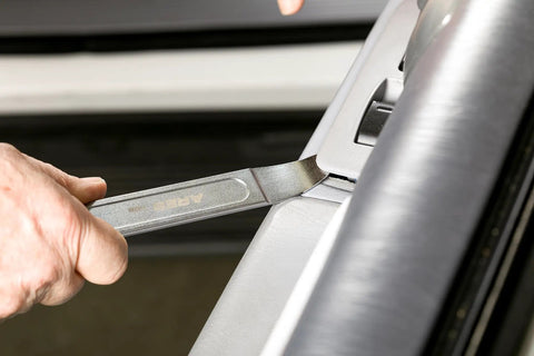 Compact Double End Metal Skin Wedge Prybar Tool By ARES, Ultra Thin 23 Gauge Ends used for panel removal on a car door.