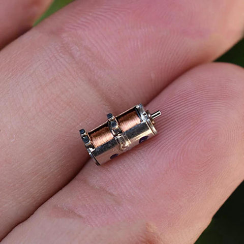 Close-up of 10Pcs DC 5V 2-Phase 4-Wire Micro Mini Ultra-Tiny 4 mm Precision Stepper Motor DIY held between fingers.