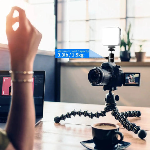 Mini Ball Head With Cold Shoe And One Quarter Inch Screw Pack Of Two For Cameras And Accessories 360 Degree Swivel And 90 Degree Tilt Compatible With DSLR Mirrorless Camcorders Smartphones LED Lighting Microphones Ring Lights Hot Shoe Adapter ST17 mounted on camera with LED light in workspace.