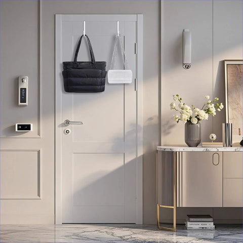 Elegantly decorated hallway with modern door, electronic lock, and stylish console table with flowers