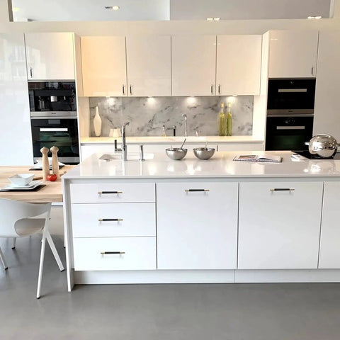 Modern kitchen with white cabinets fitted with Two Pack Knurled Aluminum Cabinet Handles With Gold And Black Oxidation Finish