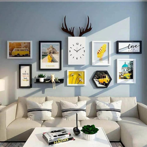 Living room with gallery wall display, featuring various framed art and clock, above a modern beige sofa and coffee table.