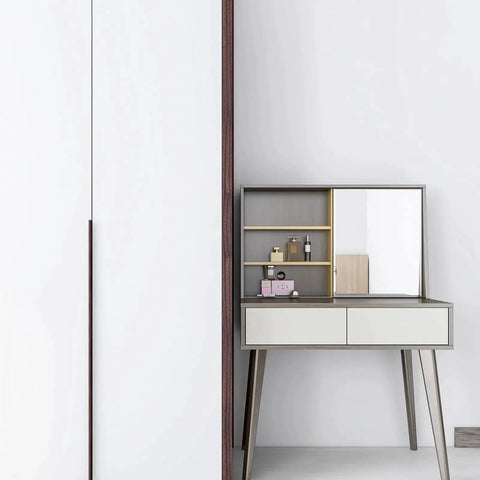 White cabinet with hidden handle and modern vanity table with mirror in room setting.