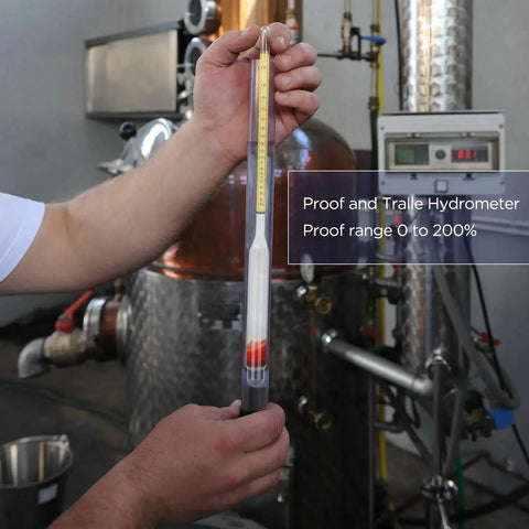Moonshine Alcohol Hydrometer Kit 0 To 100 Proof With Glass Cylinder in distillery setting, hand holding the hydrometer for measurement