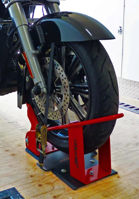 Deluxe One Size Fits All Orange And Black Motorcycle Wheel Chock With Quick Disconnect Mounting Plate And Built In Front Tire Tie Down Solid Powder Coated Steel Construction Self Locking Deluxe Wheel Chock For Easy Trailering From Lock N Load