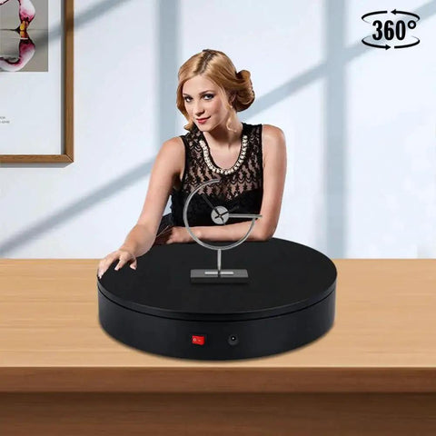 Woman demonstrating 32cm Motorized Rotating Platform With 350lbs Capacity For Photography And Display on a wooden table
