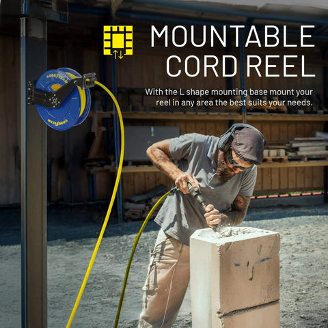 Worker using mountable cord reel attached to vertical post; retractable air hose connected to power tool on construction site.