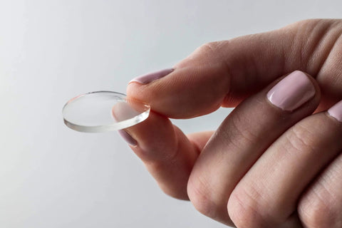 Person holding clear 1-inch circle of Nano Grab Technology Double Sided Gel Tape For Clear Mounts And Quick Fixes, Indoor Outdoor Friendly.