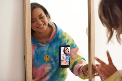 Phone mounted on a mirror using Nano Grab Technology Double Sided Gel Tape For Clear Mounts And Quick Fixes, Indoor Outdoor Friendly