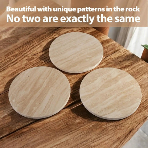 Three natural travertine round trays on wooden table, showcasing unique stone patterns, part of the Natural Travertine Lazy Susan Turntable Organizer set.