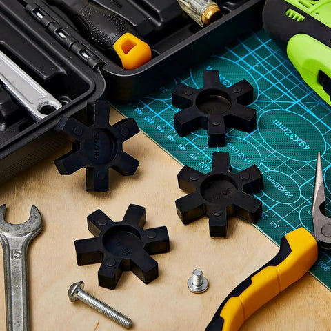 NBR Rubber Spider Center Inserts For L Jaw Couplings Four Piece Set Black, 2-1/8 Inches, shown with tools on workbench