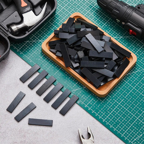 200 Pack Neoprene Setting Blocks For Glass Centering And Channel Installations Cushioned Spacers For Secure Support And Precise Alignment One Eighth By One Half By Two Inches Black displayed on workbench with tools.
