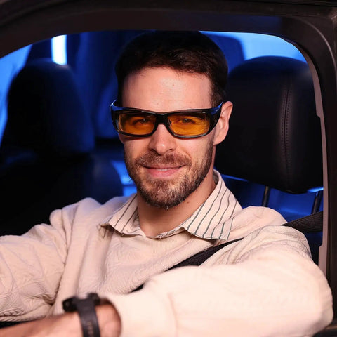 Man wearing Night Driving Glasses Fit Over Glasses Polarized Anti Glare Yellow Lens while sitting in car