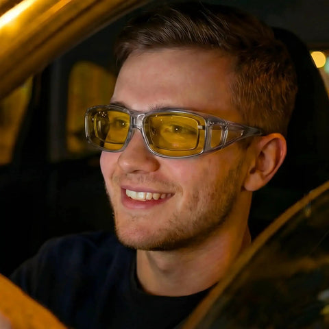 Driver wearing Night Driving Glasses With Polarized Yellow Lenses For Reduced Headlight Glare inside a car