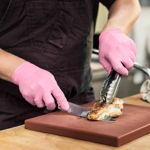 Person wearing Nitrile Exam Gloves 4 Mil Medium Cherry Blossom Powder Free Latex Free Food Safe slicing chicken