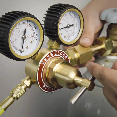 Close-up of Nitrogen Regulator With Hose For HVAC Purging And Inertization, showing gauges and connections being adjusted by a technician