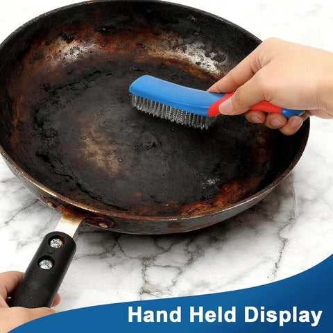 Scrubbing rust off a pan using a 4-Pack Heavy Duty Wire Brush and Scraper Set, focusing on the stainless steel scratch brush with a non-slip handle.