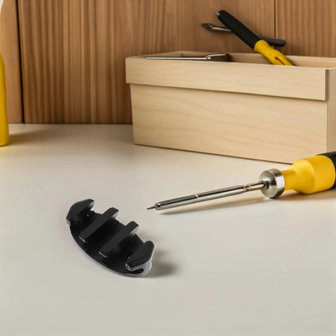 Boat rope cleat, black nylon, deck-mount mooring hardware; close-up view with screwdriver