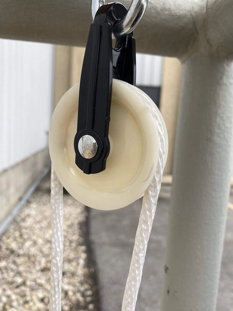 Installed 2-1/2-Inch Diameter Nylon Pulley - Durable, Smooth Outdoor Clothesline Pulley for 1/4-Inch Rope, close-up view