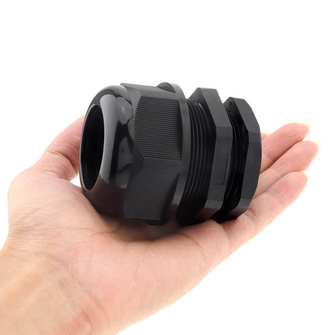 Hand holding Waterproof One And A Half Inch NPT Cable Gland With Adjustable Nylon PA66C Body And EPDM Gasket, Rugged Strain Relief Connector