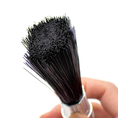Close-up of Lubricating Round Oil Brush For Chains And Guideways, Nylon Bristles Held in Hand, Ideal for Machinery Maintenance