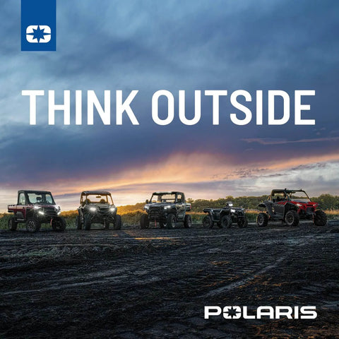 Lineup of Polaris off-road vehicles on a dirt path at sunset, with the text 'Think Outside' above.